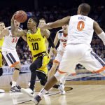UMBC's Jairus Lyles (10) drives past Virginia's Devon Hall (0) during the second half of a first-round game in the NCAA men's college basketball tournament in Charlotte, N.C., Friday, March 16, 2018. (AP Photo/Gerry Broome)