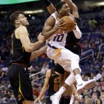 Phoenix Suns guard Shaquille Harrison (10) drives past Cleveland Cavaliers forward Ante Zizic in the second half of an NBA basketball game, Tuesday, March 13, 2018, in Phoenix. The Cavaliers defeated the Suns 129-107. (AP Photo/Rick Scuteri)