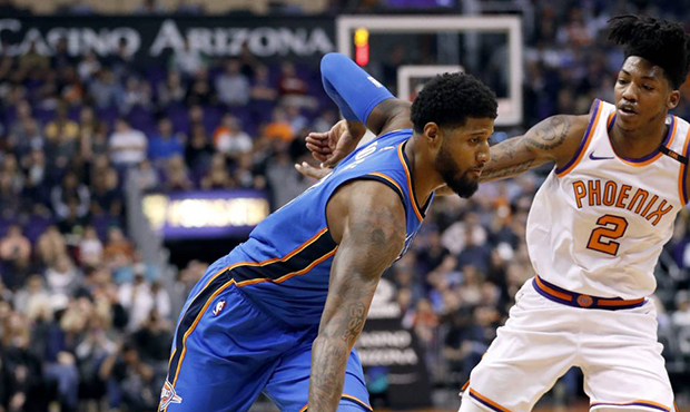 Oklahoma City Thunder forward Paul George drives against Phoenix Suns guard Elfrid Payton (2) durin...