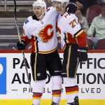 Calgary Flames defenseman Dougie Hamilton (27) smiles as he celebrates his goal against the Arizona Coyotes with center Matt Stajan during the second period of an NHL hockey game, Monday, March 19, 2018, in Glendale, Ariz. (AP Photo/Ross D. Franklin)