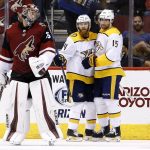 Nashville Predators defenseman Ryan Ellis (4) celebrates his goal against Arizona Coyotes goaltender Darcy Kuemper, left, with right wing Craig Smith (15) during the second period of an NHL hockey game Thursday, March 15, 2018, in Glendale, Ariz. (AP Photo/Ross D. Franklin)