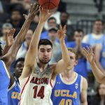 Arizona's Dusan Ristic (14) passes the ball during the first half of the team's NCAA college basketball game against UCLA in the semifinals of the Pac-12 men's tournament Friday, March 9, 2018, in Las Vegas. (AP Photo/Isaac Brekken)