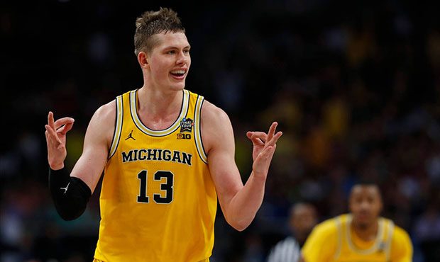 Michigan's Moritz Wagner (13) reacts after scoring a 3-point shot against Loyola-Chicago during the...