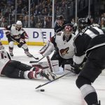 Los Angeles Kings center Anze Kopitar (11) faces Arizona Coyotes goalie Darcy Kuemper (35) in a crowd in the goal are during the second period of an NHL hockey game in Los Angeles Thursday, March 29, 2018. (AP Photo/Reed Saxon)