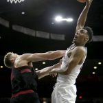 Arizona guard Allonzo Trier (35) shoots over Stanford forward Reid Travis during the second half of an NCAA college basketball game Thursday, March 1, 2018, in Tucson, Ariz. Arizona defeated Stanford 75-67. (AP Photo/Rick Scuteri)