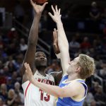 UCLA's Thomas Welsh, right, defends on a shot from Arizona's Deandre Ayton during the second half of an NCAA college basketball game in the semifinals of the Pac-12 men's tournament Friday, March 9, 2018, in Las Vegas. Arizona won 78-67 in overtime. (AP Photo/Isaac Brekken)