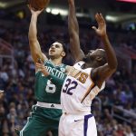 Boston Celtics guard Shane Larkin (8) drives past Phoenix Suns guard Davon Reed (32) during the first half of an NBA basketball game Monday, March 26, 2018, in Phoenix. (AP Photo/Ross D. Franklin)
