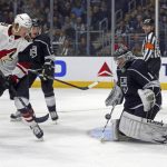 Los Angeles Kings goalie Jack Campbell (1) blocks the puck as Arizona Coyotes center Christian Dvorak (18) watches during the first period of an NHL hockey game in Los Angeles on Thursday, March 29, 2018. (AP Photo/Reed Saxon)