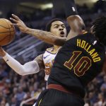 Phoenix Suns guard Tyler Ulis (8) drives on Cleveland Cavaliers guard John Holland in the second half during an NBA basketball game, Tuesday, March 13, 2018, in Phoenix. The Cavaliers defeated the Suns 129-107. (AP Photo/Rick Scuteri)