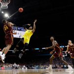 Michigan guard Zavier Simpson (3) shoots over Loyola-Chicago forward Aundre Jackson (24) during the second half in the semifinals of the Final Four NCAA college basketball tournament, Saturday, March 31, 2018, in San Antonio. (AP Photo/David J. Phillip)