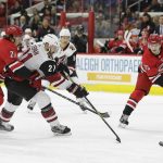 Arizona Coyotes' Derek Stepan (21) chasse the puck with Carolina Hurricanes' Justin Faulk (27) and Valentin Zykov (73) during the first period of an NHL hockey game in Raleigh, N.C., Thursday, March 22, 2018. (AP Photo/Gerry Broome)