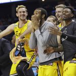 UMBC players celebrate a teammate's basket against Virginia during the second half of a first-round game in the NCAA men's college basketball tournament in Charlotte, N.C., Friday, March 16, 2018. (AP Photo/Gerry Broome)