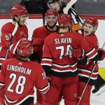 Carolina Hurricanes' Jeff Skinner, right, is congratulated by Jaccob Slavin (74); Elias Lindholm (28), of Sweden; Phillip Di Giuseppe and Trevor van Riemsdyk (57) following Skinner's goal during the third period of an NHL hockey game against the Arizona Coyotes in Raleigh, N.C., Thursday, March 22, 2018. Carolina won 6-5. (AP Photo/Gerry Broome)