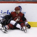 Arizona Coyotes right wing Richard Panik (14) and Los Angeles Kings right wing Dustin Brown (23) get tangled up and neither are able to get to the puck during the second period of an NHL hockey game Tuesday, March 13, 2018, in Glendale, Ariz. (AP Photo/Ross D. Franklin)