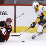 Nashville Predators right wing Craig Smith (15) gets control of the puck as Arizona Coyotes defenseman Jakob Chychrun (6) slides past during the third period of an NHL hockey game Thursday, March 15, 2018, in Glendale, Ariz. The Predators won 3-2. (AP Photo/Ross D. Franklin)