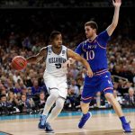 Villanova guard Phil Booth drives past Kansas guard Sviatoslav Mykhailiuk, right, during the first half in the semifinals of the Final Four NCAA college basketball tournament, Saturday, March 31, 2018, in San Antonio. (AP Photo/Eric Gay)