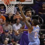 Los Angeles Clippers guard Sindarius Thornwell (0) shoots over Phoenix Suns forward Marquese Chriss during the second half of an NBA basketball game Wednesday, March 28, 2018, in Phoenix. (AP Photo/Matt York)