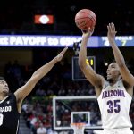 Colorado's D'Shawn Schwartz, left, covers a shot by Arizona's Allonzo Trier during the first half of an NCAA college basketball game in the quarterfinals of the Pac-12 men's tournament Thursday, March 8, 2018, in Las Vegas. (AP Photo/Isaac Brekken)