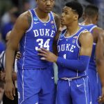 Duke's Trevon Duval, right, talks with teammate Wendell Carter Jr during the second half of a regional final game against Kansas in the NCAA men's college basketball tournament Sunday, March 25, 2018, in Omaha, Neb. (AP Photo/Charlie Neibergall)