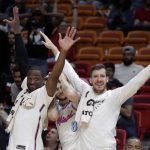 Miami Heat's Dwyane Wade, left, Tyler Johnson (8) and Goran Dragic react in the closing seconds of an NBA basketball game against the Phoenix Suns, Monday, March 5, 2018, in Miami. (AP Photo/Lynne Sladky)