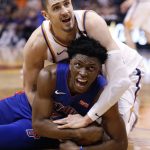 Phoenix Suns center Alex Len, top, and Detroit Pistons forward Stanley Johnson look for a call during the second half of an NBA basketball game Tuesday, March 20, 2018, in Phoenix. (AP Photo/Matt York)