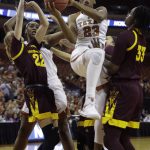 Texas guard Ariel Atkins (23) drives to the basket between Arizona State guard Courtney Ekmark (22) and center Charnea Johnson-Chapman (33) during a second-round game in the NCAA women's college basketball tournament, Monday, March 19, 2018, in Austin, Texas. (AP Photo/Eric Gay)