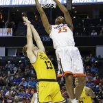 Virginia's Mamadi Diakite (25) shoots over UMBC's Joe Sherburne (13) during the first half of a first-round game in the NCAA men's college basketball tournament in Charlotte, N.C., Friday, March 16, 2018. (AP Photo/Gerry Broome)