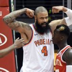Phoenix Suns center Tyson Chandler (4) flexes his muscles after dunking near Atlanta Hawks guard Dennis Schroder, right, during the second half of an NBA basketball game Sunday, March 4, 2018, in Atlanta. (AP Photo/John Amis)