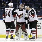 Arizona Coyotes goaltender Antti Raanta, center, celebrates with defenseman Kevin Connauton (44) and right wing Richard Panik (14) after they defeated the Tampa Bay Lightning in an NHL hockey game Monday, March 26, 2018, in Tampa, Fla. (AP Photo/Chris O'Meara)