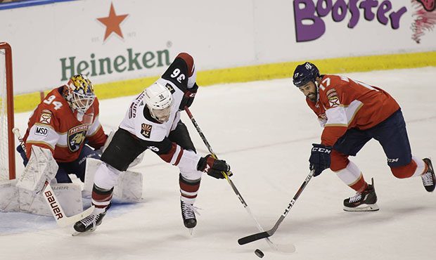 Arizona Coyotes right wing Christian Fischer (36) and Florida Panthers center Derek MacKenzie (17) ...