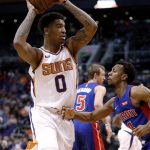 Phoenix Suns forward Marquese Chriss (0) is defended by Detroit Pistons guard Ish Smith (14) during the second half of an NBA basketball game Tuesday, March 20, 2018, in Phoenix. (AP Photo/Matt York)
