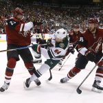 Minnesota Wild right wing Mikael Granlund (64) gets off a shot between Arizona Coyotes defenseman Oliver Ekman-Larsson (23) and defenseman Jason Demers (55) during the first period of an NHL hockey game Saturday, March 17, 2018, in Glendale, Ariz. (AP Photo/Ross D. Franklin)