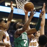 Boston Celtics guard Jaylen Brown (7) loses the ball as he tries to go up for a shot between Phoenix Suns forward Dragan Bender, right, and forward Marquese Chriss, left, during the first half of an NBA basketball game Monday, March 26, 2018, in Phoenix. (AP Photo/Ross D. Franklin)