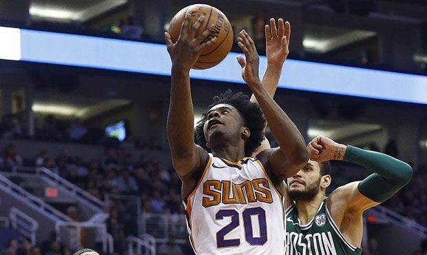 Phoenix Suns guard Josh Jackson (20) drives past Boston Celtics forward Jayson Tatum (0) and forwar...