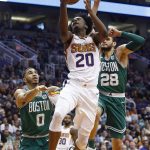 Phoenix Suns guard Josh Jackson (20) drives past Boston Celtics forward Jayson Tatum (0) and forward Abdel Nader (28) during the second half of an NBA basketball game, Monday, March 26, 2018, in Phoenix. The Celtics defeated the Suns 102-94. (AP Photo/Ross D. Franklin)