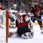Arizona Coyotes goaltender Antti Raanta (32) gives up a goal to Minnesota Wild's Marcus Foligno as Coyotes defenseman Jakob Chychrun (6), Coyotes center Derek Stepan (21) and Wild center Joel Eriksson Ek, second from left, look on during the third period of an NHL hockey game Saturday, March 17, 2018, in Glendale, Ariz. The Wild defeated the Coyotes 3-1. (AP Photo/Ross D. Franklin)