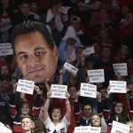 Fans in the Arizona student section hold up signs during the first half of the team's NCAA college basketball game against Stanford, Thursday, March 1, 2018, in Tucson, Ariz. (AP Photo/Rick Scuteri)