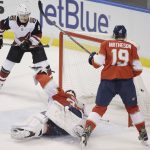 Arizona Coyotes center Clayton Keller (9) scores a goal as Florida Panthers goaltender James Reimer (34) and defenseman Mike Matheson (19) defend during the first period of an NHL hockey game in Sunrise, Fla., Saturday, March 24, 2018. (AP Photo/Terry Renna)