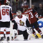 Ottawa Senators goaltender Mike Condon, center, reacts after giving up a goal to Arizona Coyotes defenseman Oliver Ekman-Larsson, right, during the first period of an NHL hockey game Saturday, March 3, 2018, in Glendale, Ariz. (AP Photo/Ross D. Franklin)