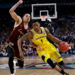 Michigan guard Charles Matthews drives past Loyola-Chicago guard Lucas Williamson, left, during the second half in the semifinals of the Final Four NCAA college basketball tournament, Saturday, March 31, 2018, in San Antonio. (AP Photo/David J. Phillip)