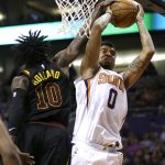 Cleveland Cavaliers guard John Holland (10) blocks the shot of Phoenix Suns forward Marquese Chriss in the second half of an NBA basketball game, Tuesday, March 13, 2018, in Phoenix. The Cavaliers defeated the Suns 129-107. (AP Photo/Rick Scuteri)