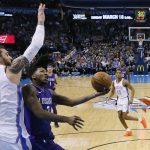 Phoenix Suns guard Elfrid Payton goes to the basket in front of Oklahoma City Thunder center Steven Adams (12) during the first half of an NBA basketball game in Oklahoma City, Thursday, March 8, 2018. (AP Photo/Sue Ogrocki)