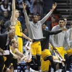UMBC players celebrate a teammate's basket against Virginia during the second half of a first-round game in the NCAA men's college basketball tournament in Charlotte, N.C., Friday, March 16, 2018. (AP Photo/Bob Leverone)
