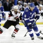 Tampa Bay Lightning defenseman Dan Girardi (5) controls the puck in front of Arizona Coyotes center Brad Richardson (15) during the first period of an NHL hockey game Monday, March 26, 2018, in Tampa, Fla. (AP Photo/Chris O'Meara)