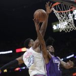 Phoenix Suns' Elfrid Payton (2) goes up for a basket as Miami Heat's Hassan Whiteside (21) defends during the first half of an NBA basketball game, Monday, March 5, 2018, in Miami. (AP Photo/Lynne Sladky)