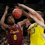 Loyola-Chicago's Donte Ingram (0) and Michigan's Moritz Wagner (13) battle for a rebound during the first half in the semifinals of the Final Four NCAA college basketball tournament, Saturday, March 31, 2018, in San Antonio. (AP Photo/Eric Gay)