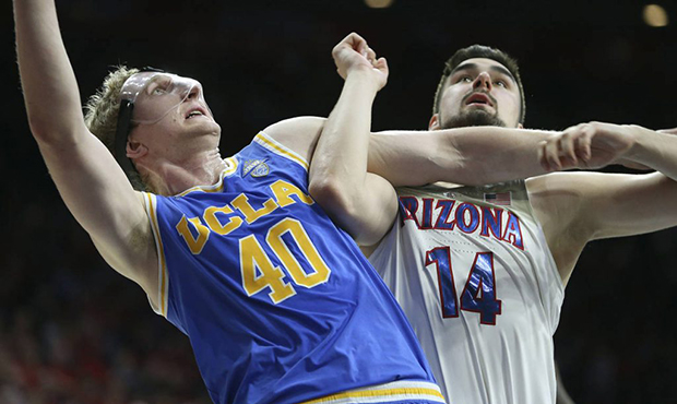 UCLA center Thomas Welsh (40) and Arizona's Dusan Ristic (14) wait for a rebound during the second ...