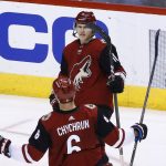 Arizona Coyotes center Christian Dvorak (18) celebrates his goal against the Los Angeles Kings with Jakob Chychrun (6) during the second period of an NHL hockey game Tuesday, March 13, 2018, in Glendale, Ariz. (AP Photo/Ross D. Franklin)