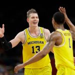 Michigan's Moritz Wagner (13) celebrates with Charles Matthews (1) during the second half in the semifinals of the Final Four NCAA college basketball tournament against Loyola-Chicago, Saturday, March 31, 2018, in San Antonio. (AP Photo/Eric Gay)