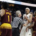 Referees break up an altercation between Arizona State and Colorado players during the second half of an NCAA college basketball game in the first round of the Pac-12 men's tournament Wednesday, March 7, 2018, in Las Vegas. Colorado defeated Arizona State 97-85. (AP Photo/Isaac Brekken)